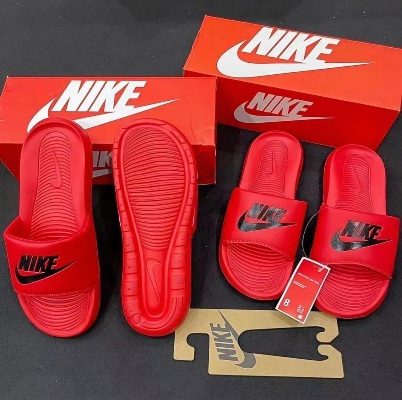 Red Nike Victori One Slide in multiple views with red Nike boxes and tags.