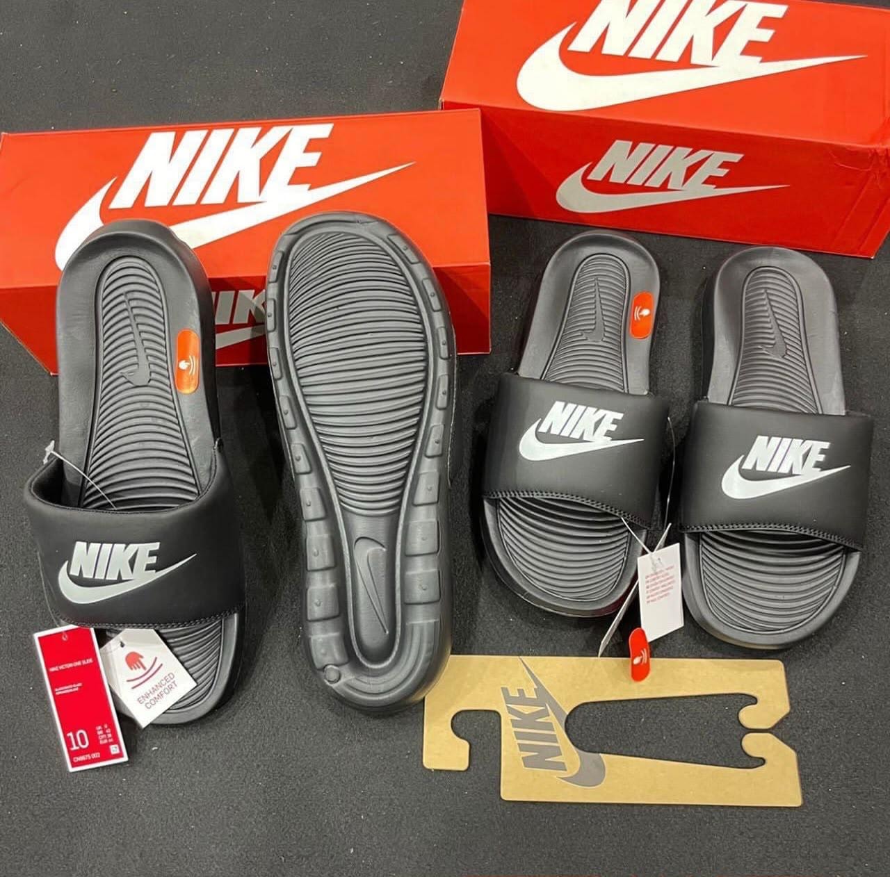 Black Nike Victori One Slide top and sole views with Nike box and size tags.