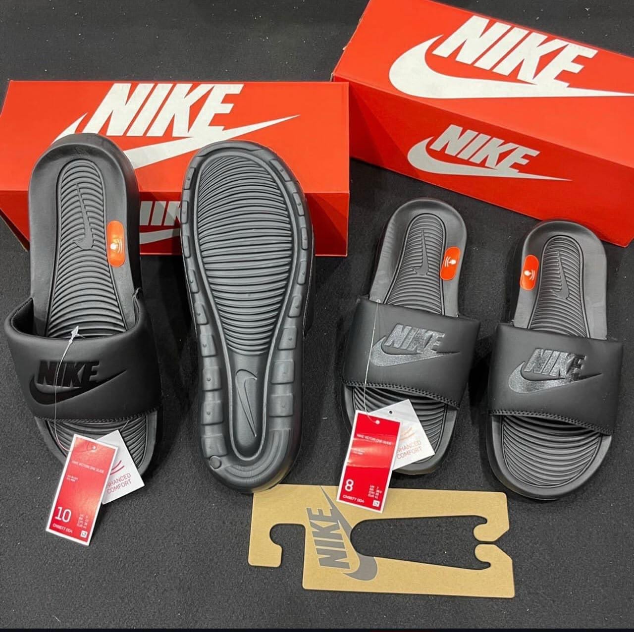 Black Nike Victori One Slide shown in multiple angles with red Nike box and tags.