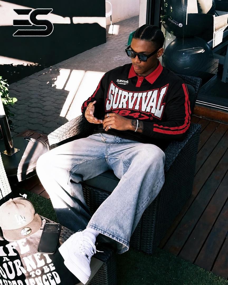 Black long sleeve polo with red collar, stripes and SURVIVAL 1847 chest graphic.