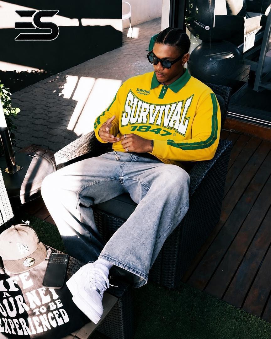 Yellow long sleeve polo with green collar, stripes and SURVIVAL 1847 chest graphic.