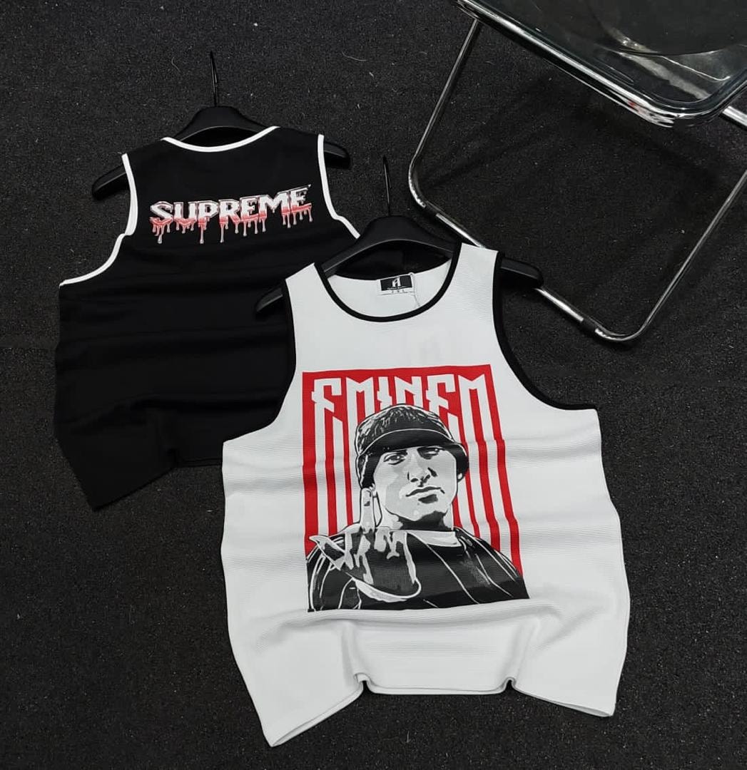 White armless polo with Eminem graphic on front and black armless polo with Supreme dripping text on back.