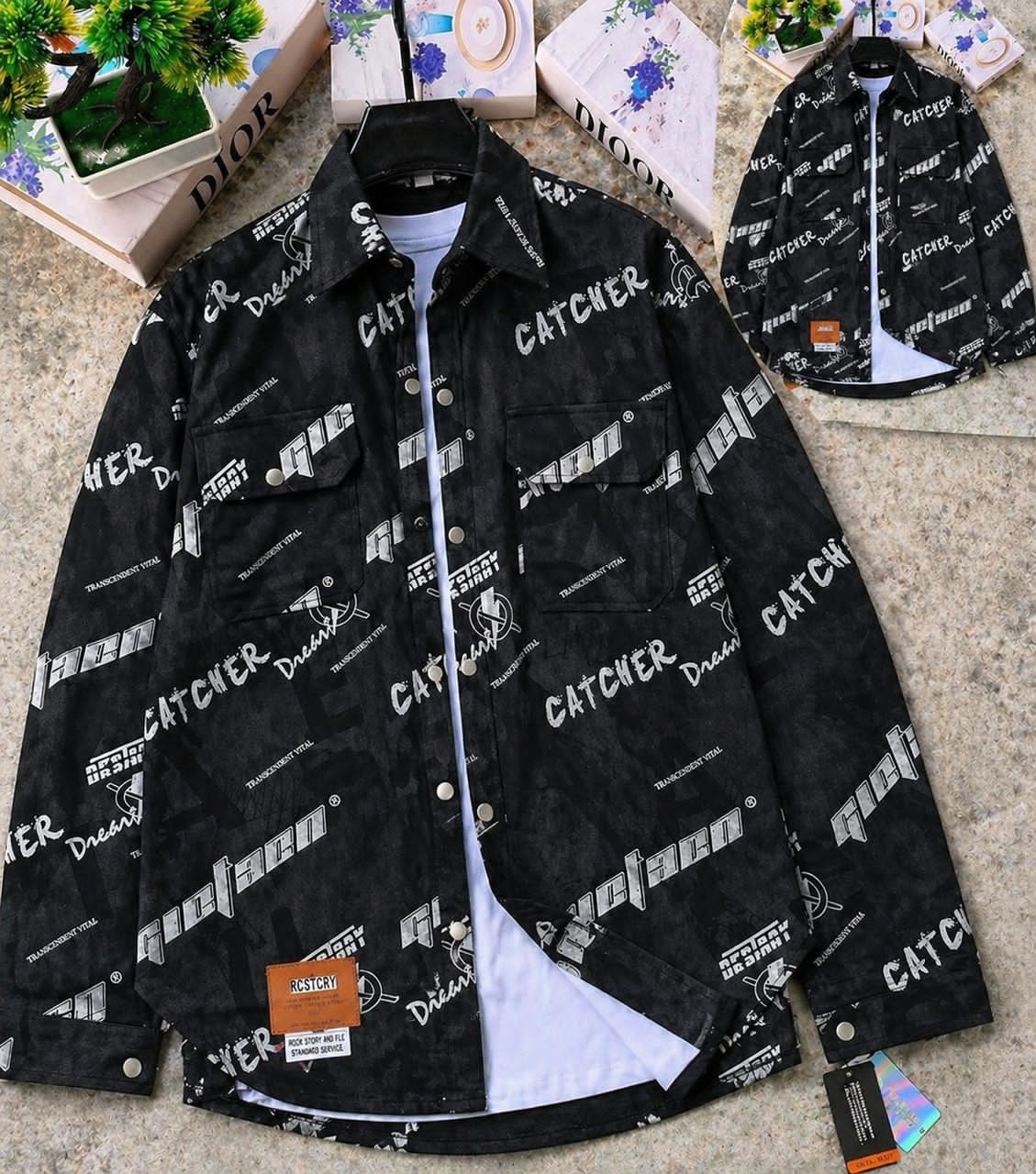 Black text graphic denim jacket layered on white tee, with visible tags and back view inset.