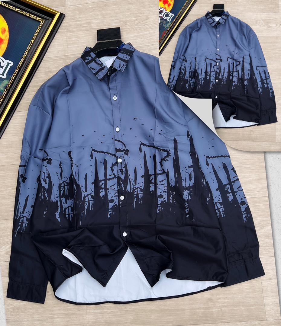 Blue gradient cityscape splatter print long sleeve shirt laid flat.