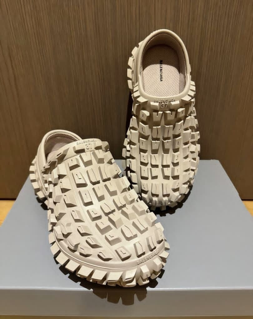 Cream Balenciaga chunky clog displayed on stand showing tread sole and mesh interior.