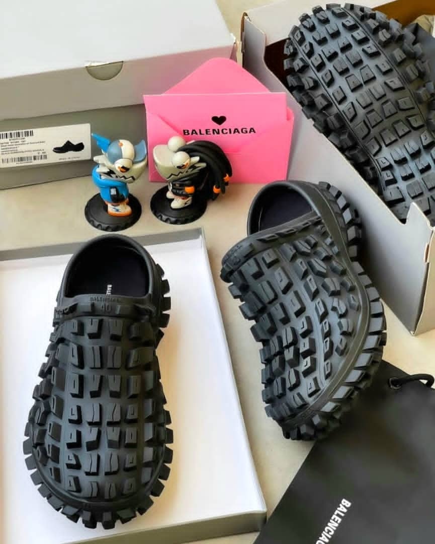 Black Balenciaga chunky clog with thick tread sole and branded details.