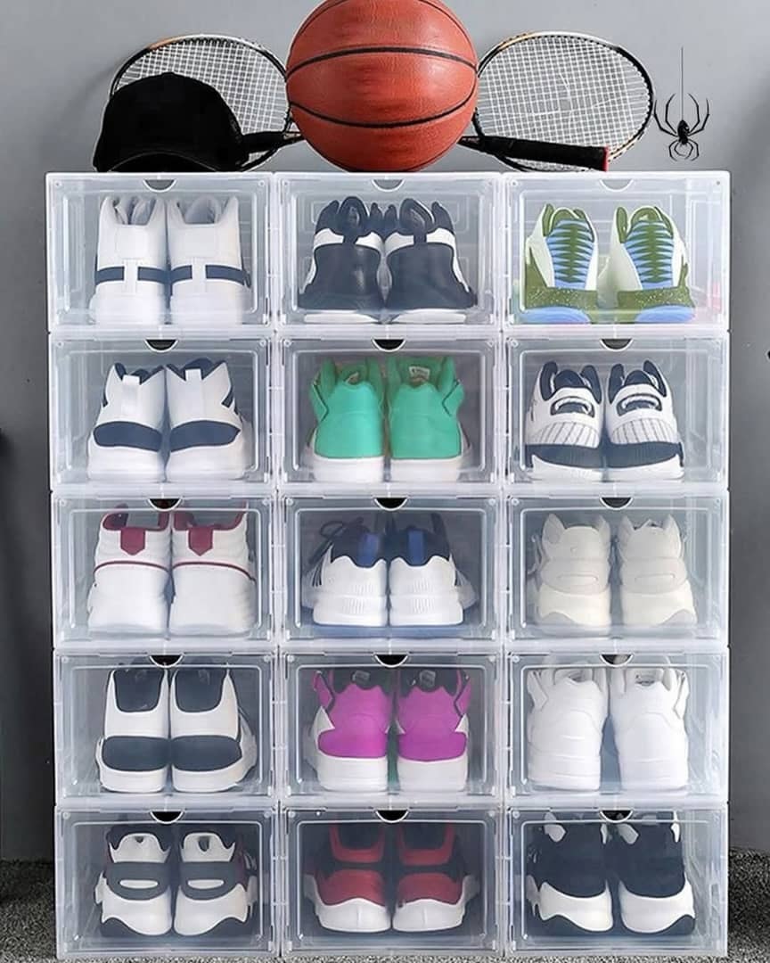Stack of transparent acrylic shoe boxes arranged in a grid, each holding a different pair of sneakers.