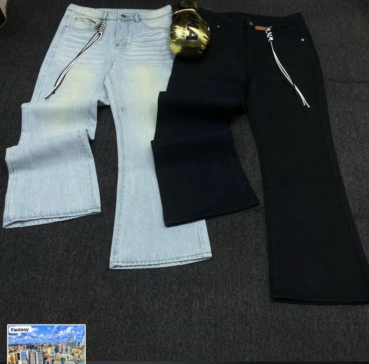 Light blue and black flared jeans with waist drawstrings shown side by side on dark surface.