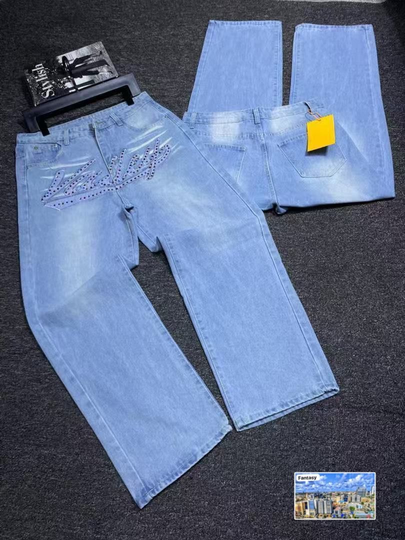 Light blue baggy jeans with studded Versace design on back pockets, flat lay showing front and back.