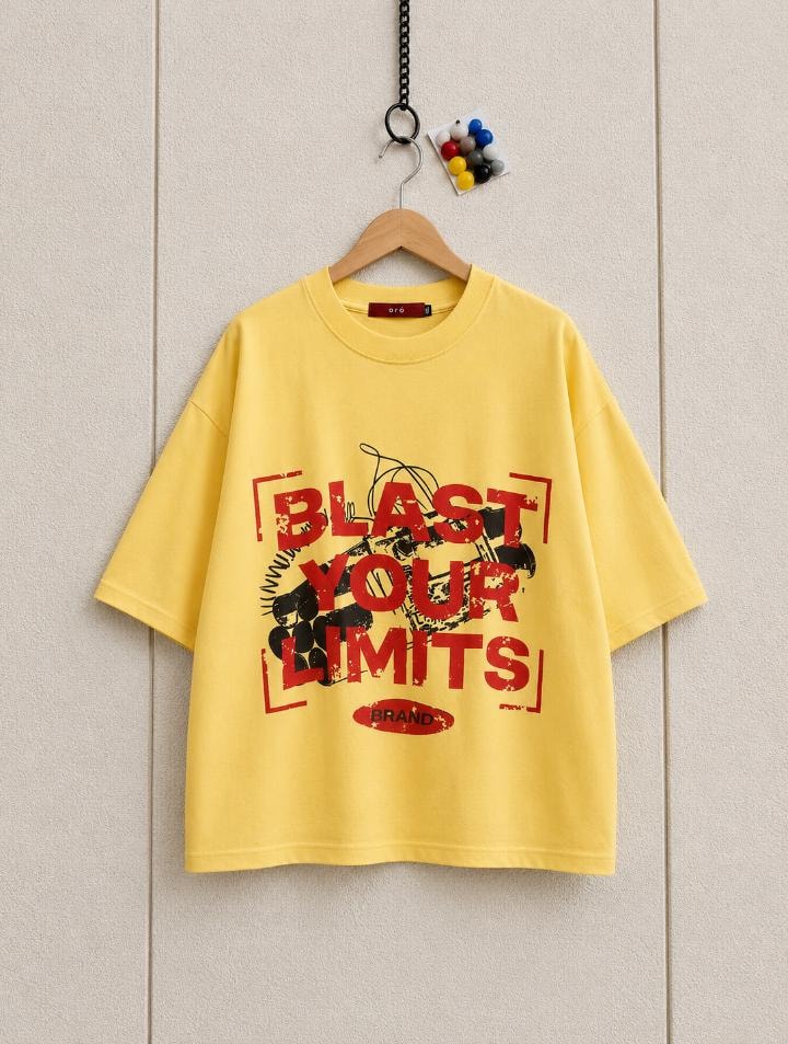 Yellow cropped tee hanging showing Blast Your Limits distressed graphic.