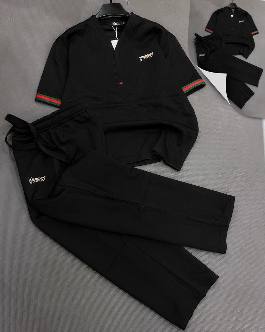 Black Omega unisex two-piece set shown in multiple flat lay views.