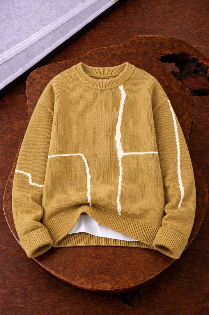 Olive knit sweater with white geometric line patterns on body and sleeves.