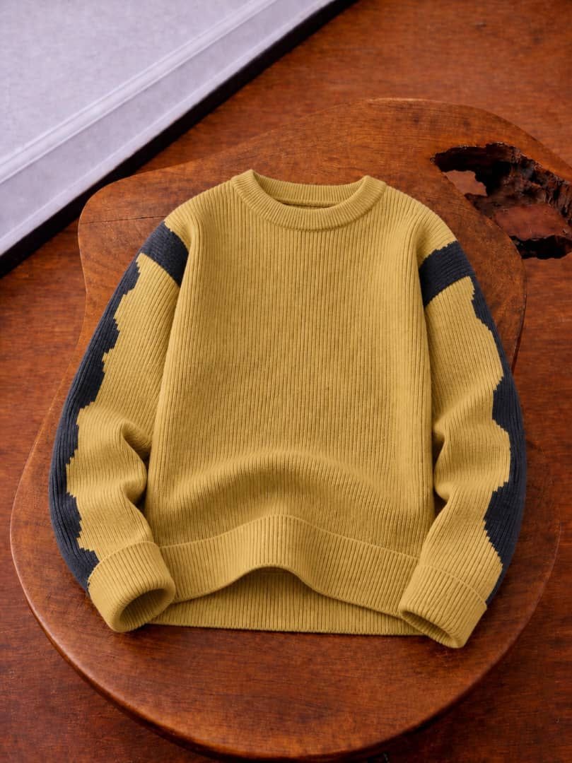 Olive knit sweater with dark contrast zigzag panels on shoulders and sleeves.