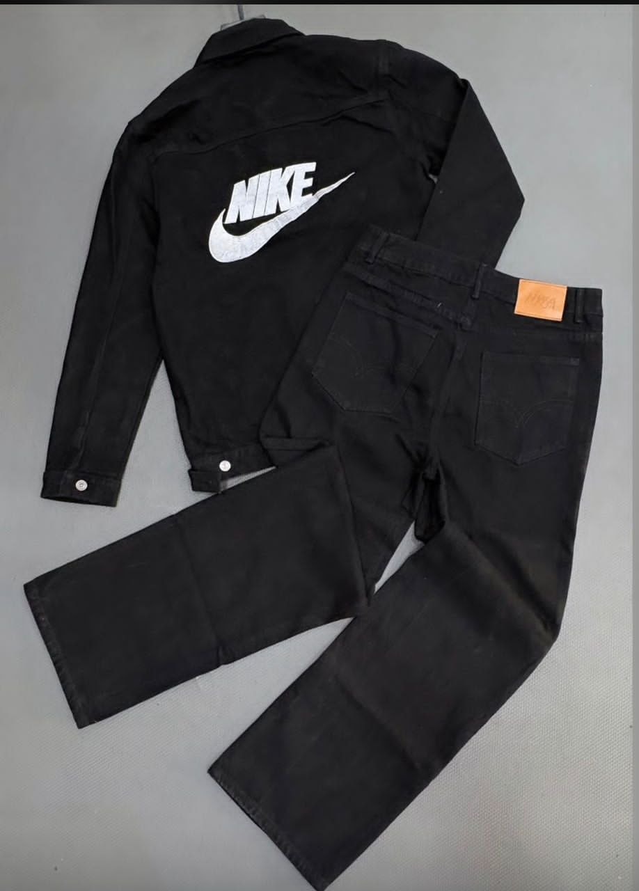Flat lay of black Nike denim jacket with large back Swoosh logo and matching pants.