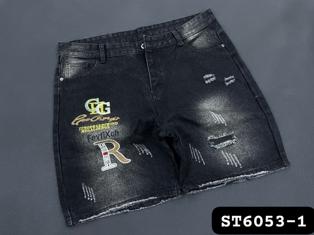 Black denim shorts with multiple colorful logos, text embroidery and heavy distressing.