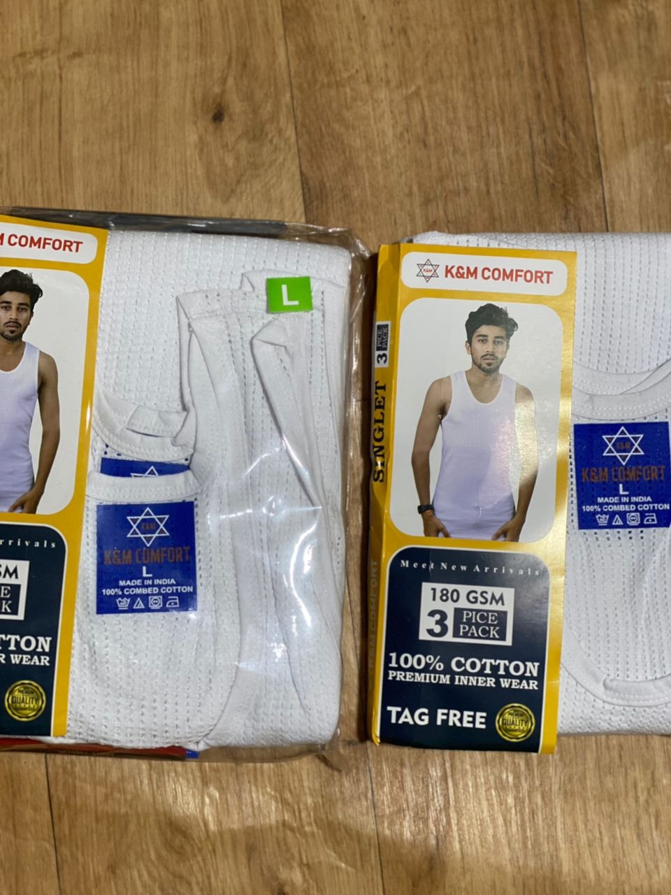 Close view of K&M Comfort white singlet 3-piece pack with branding and size L label.