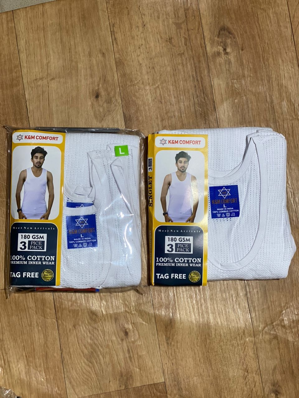 K&M Comfort 3-pack white singlets in packaging showing size L on wooden surface.