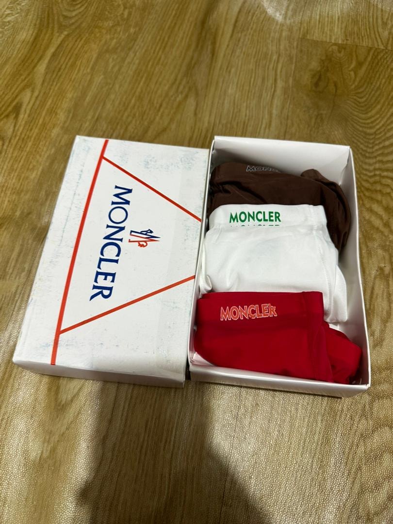 Moncler white box with brown, white, and red Moncler boxer briefs.