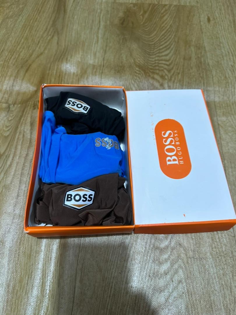 Hugo Boss orange and white box with black, blue, and brown boxer briefs.