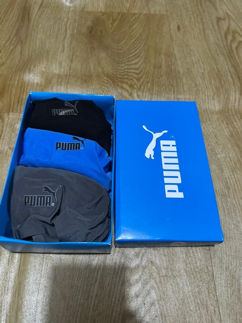 Blue Puma box with black, blue, and gray Puma boxer briefs.