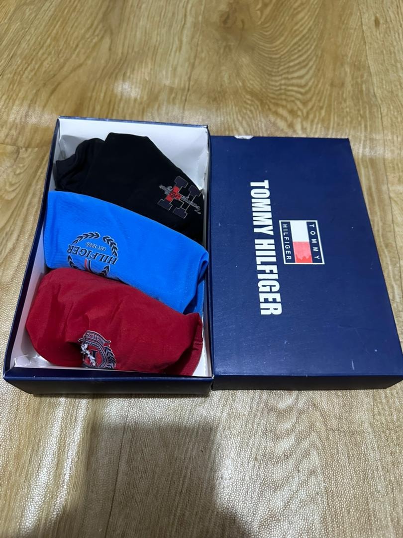 Tommy Hilfiger box with black, blue, and red boxer briefs.