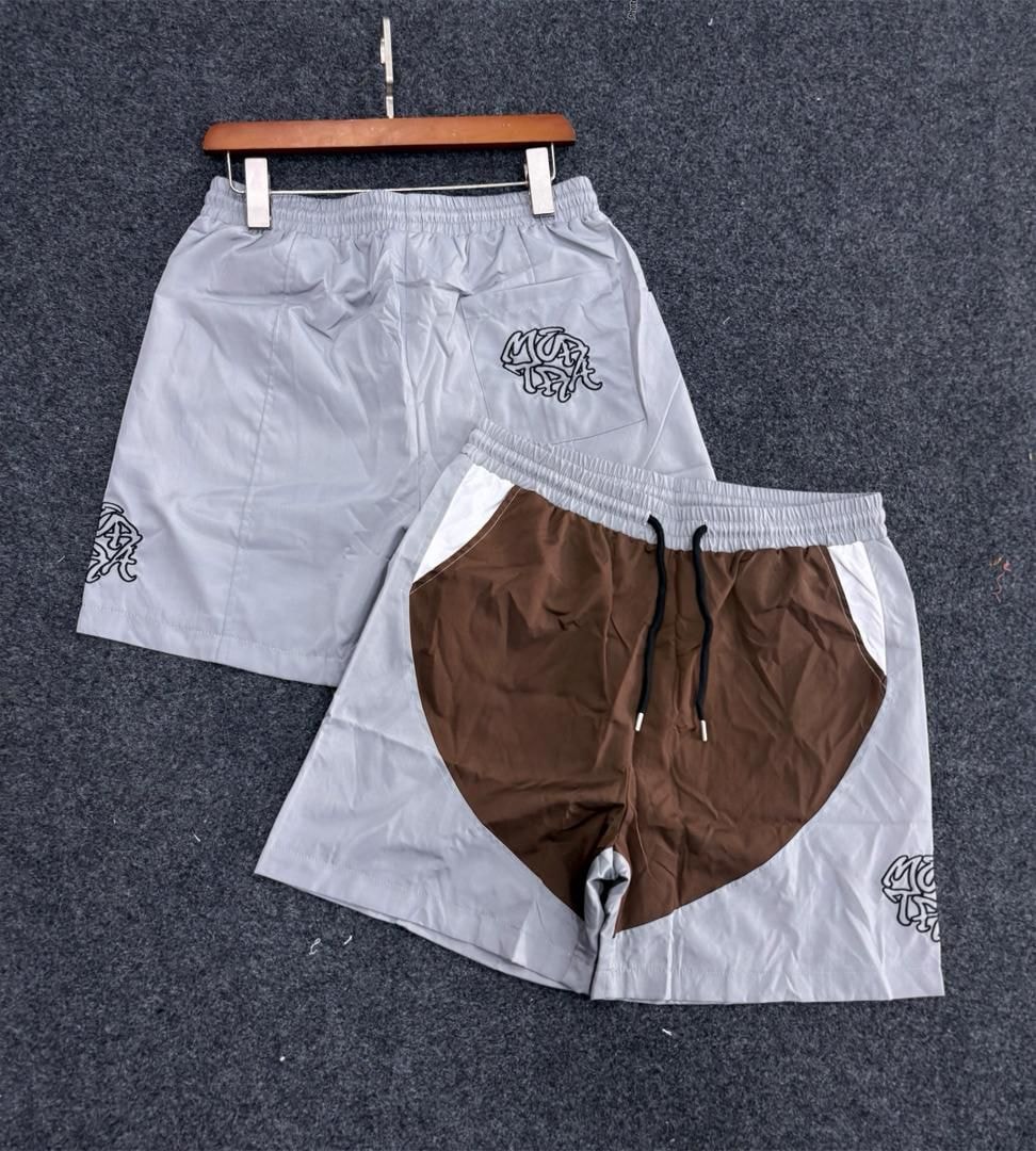 Light gray and brown colorblock shorts with graffiti logo shown side by side.
