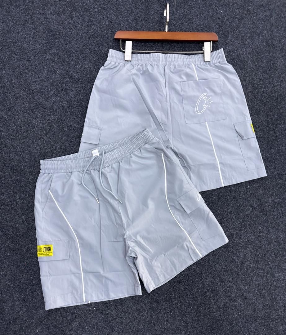 Light gray cargo shorts with flap pockets, white piping and embroidered logo.