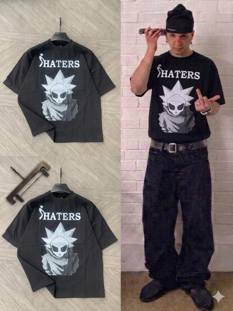 Oversized black t-shirt with SHATERS skull graphic, shown on hanger and model.