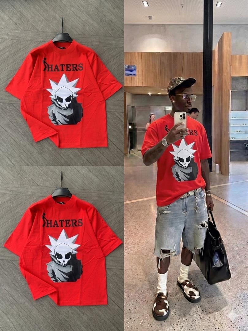 Oversized red t-shirt with SHATERS skull graphic, shown on hanger and model.