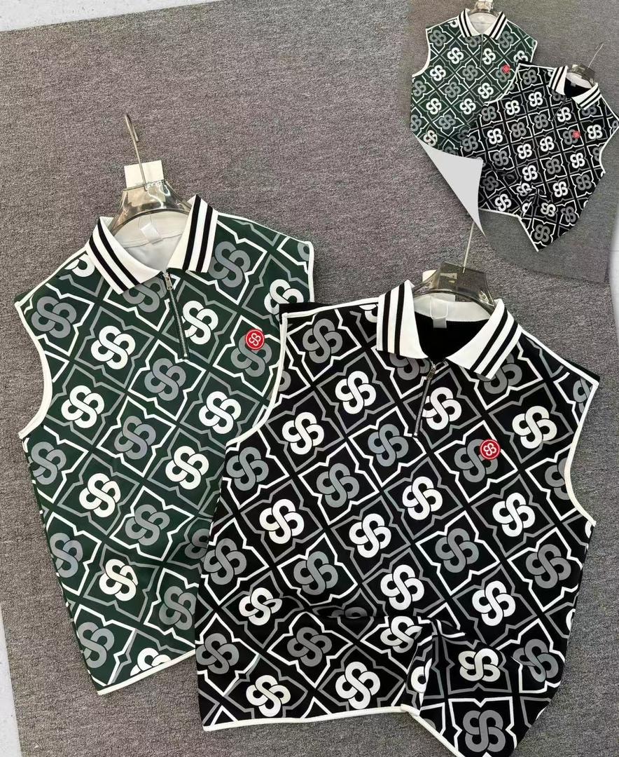 Green and black monogram armless polos displayed on hangers.