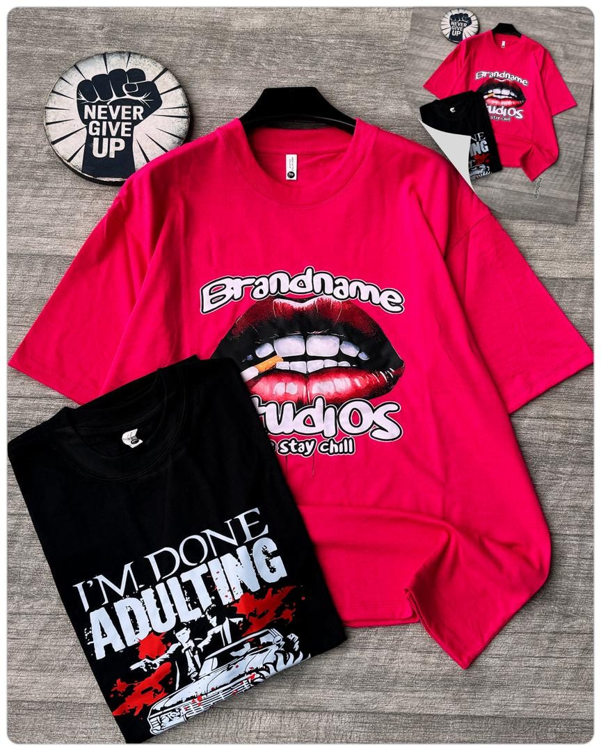 Red oversized t-shirt with lips and Brandname Studios graphic displayed with folded black adulting tee.