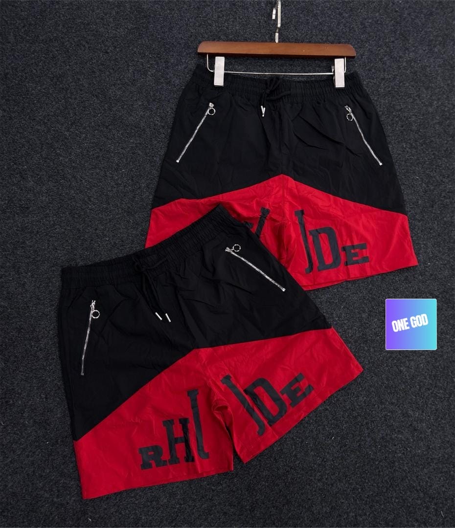Black and red two-tone graphic cargo shorts with side zip pockets.