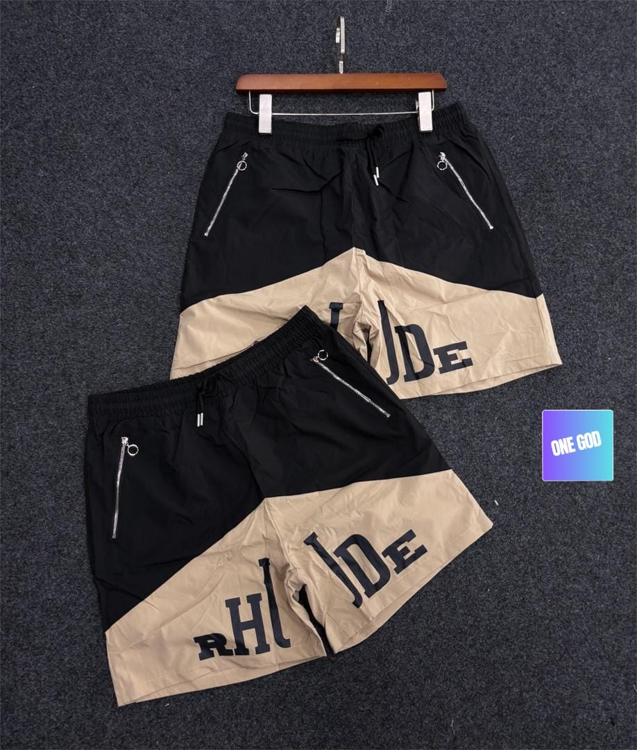 Black and beige two-tone graphic cargo shorts with side zip pockets.
