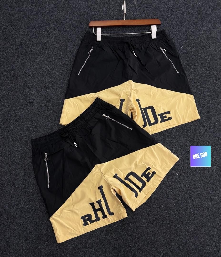 Black and yellow two-tone graphic cargo shorts with side zip pockets.