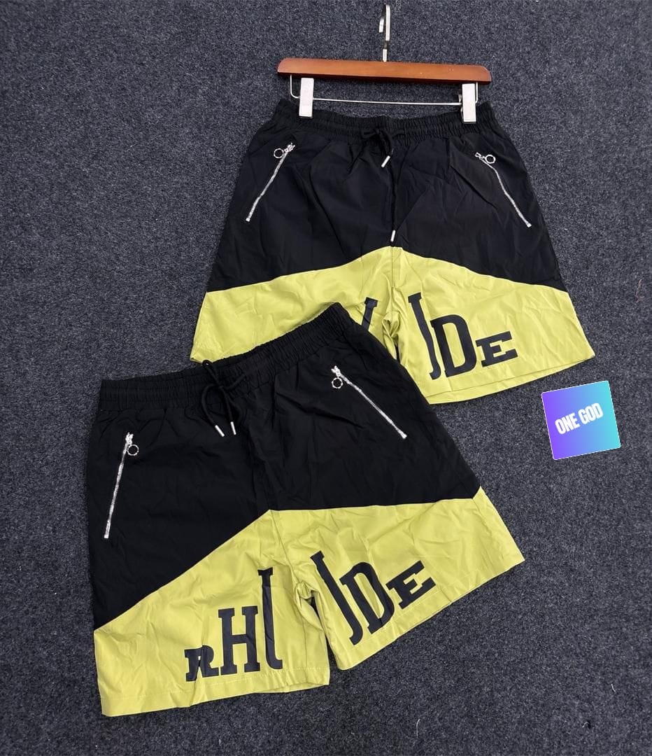 Black and yellow two-tone graphic cargo shorts with side zip pockets.