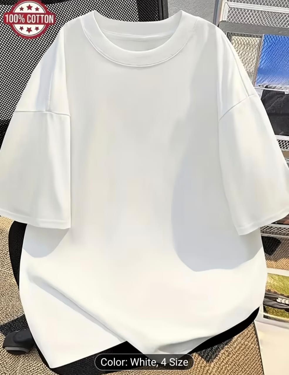 White plain oversized t-shirt with 100% cotton badge shown on chair.