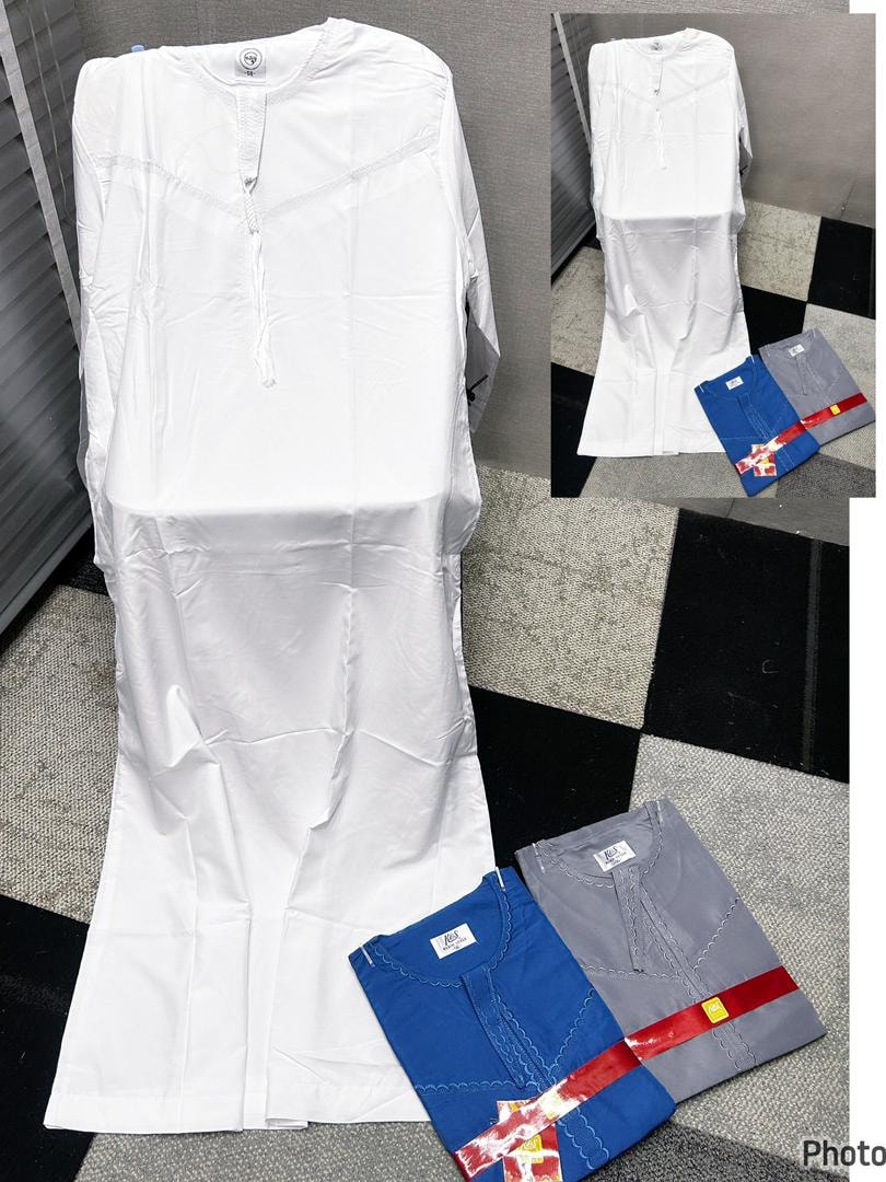 Plain white jalamia displayed with folded blue and gray versions on checkered floor.