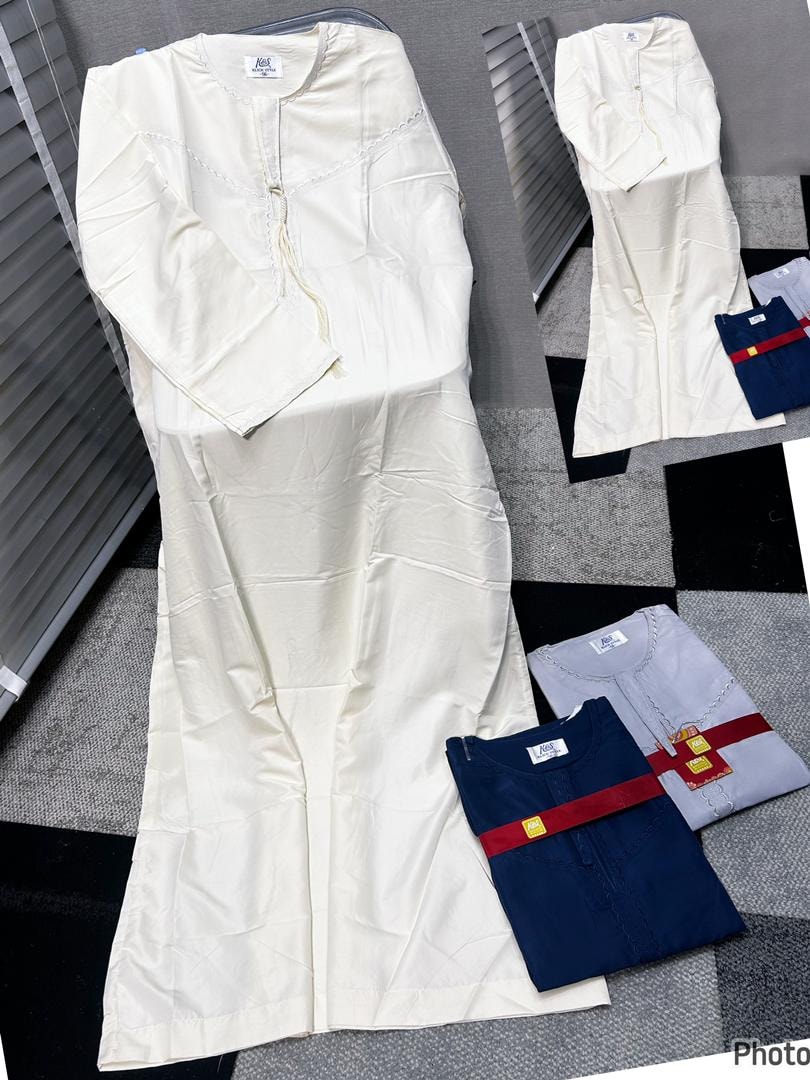Off-white jalamia with scalloped lace trim laid flat alongside folded navy and gray versions.