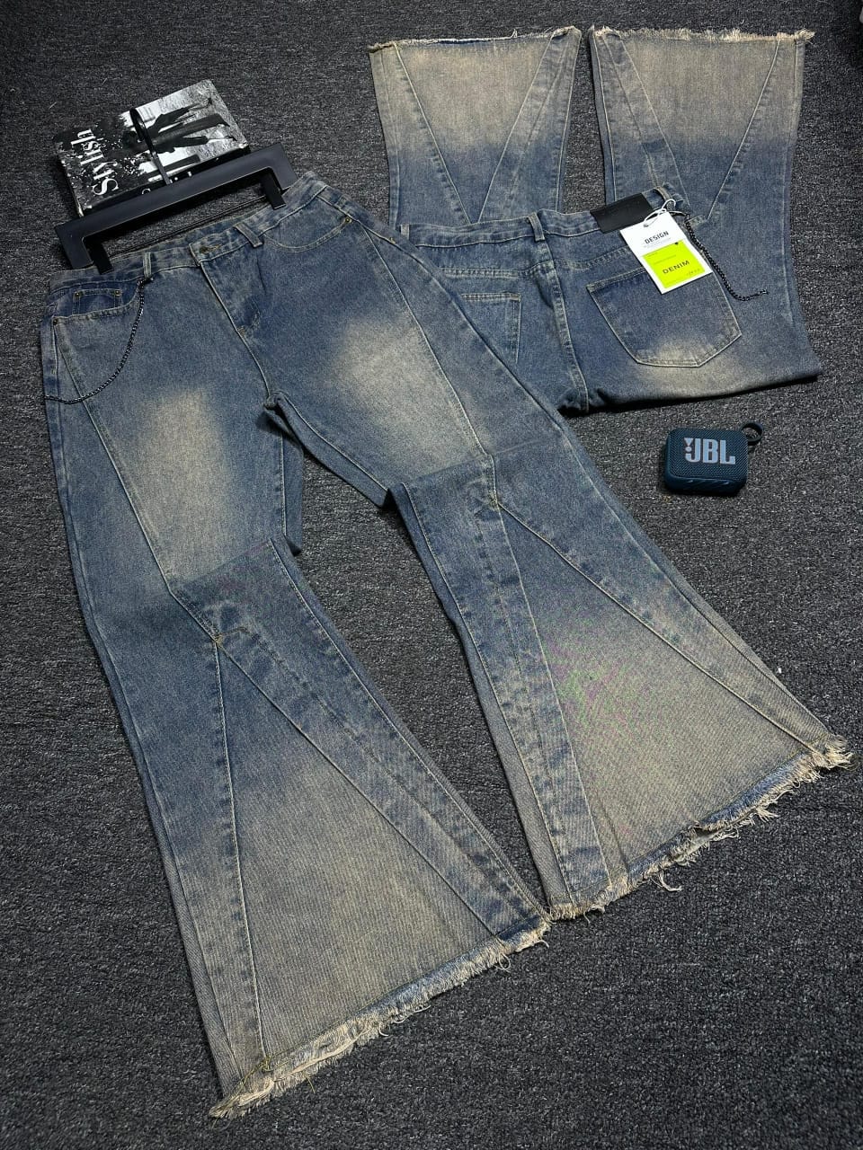 Baggy flared jeans in blue wash with frayed hem, front and back views with accessories.