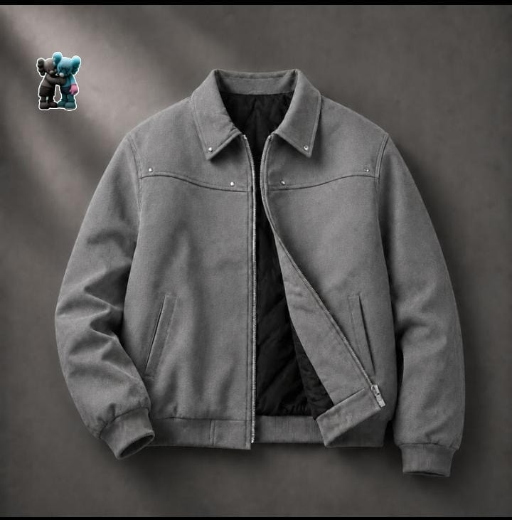 Gray suede bomber jacket with zip closure and black quilted lining.
