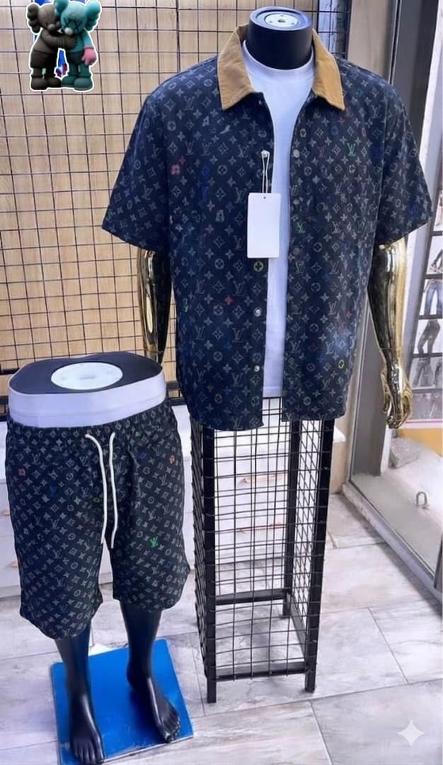 Dark multicolor monogram short-sleeve shirt with brown collar and matching shorts on mannequins.