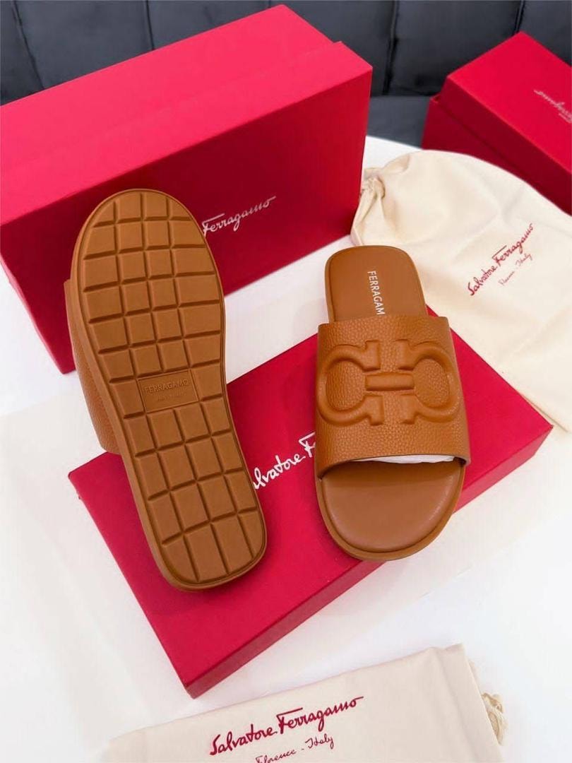 Brown Ferragamo Gancio slides displayed with red boxes, dust bag and detailed sole view.