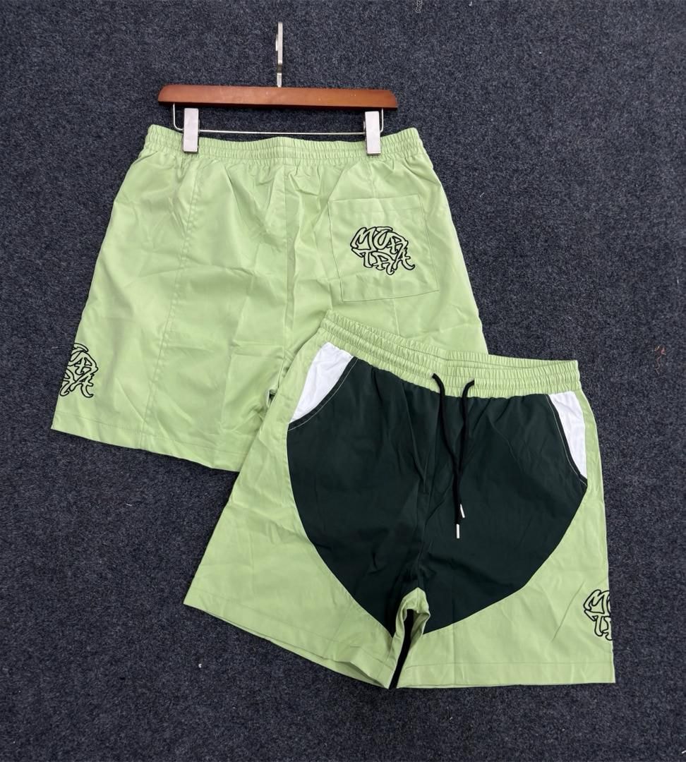 Lime green graffiti logo shorts with heart colorblock detail.