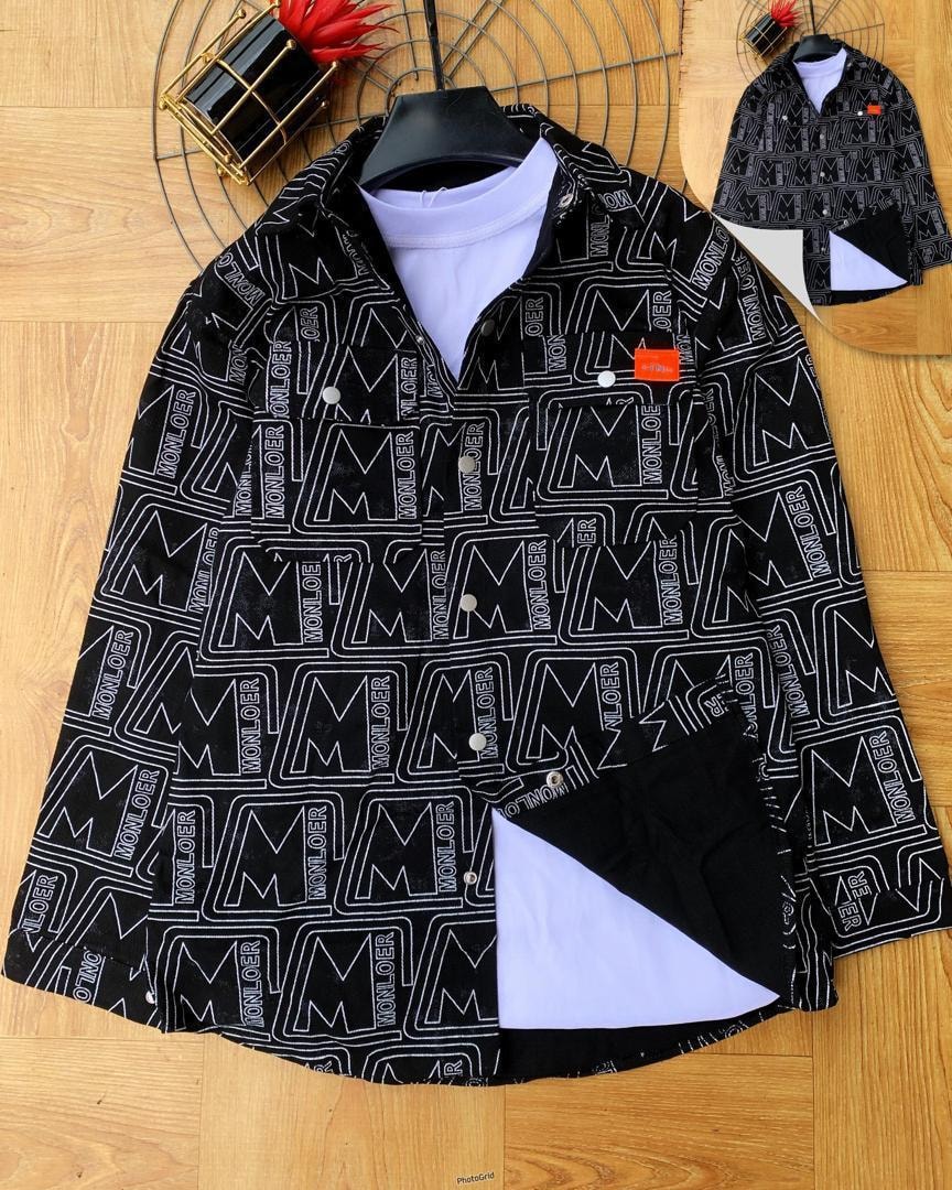 Black monogram print jacket shown on wooden floor with white repeating logos.