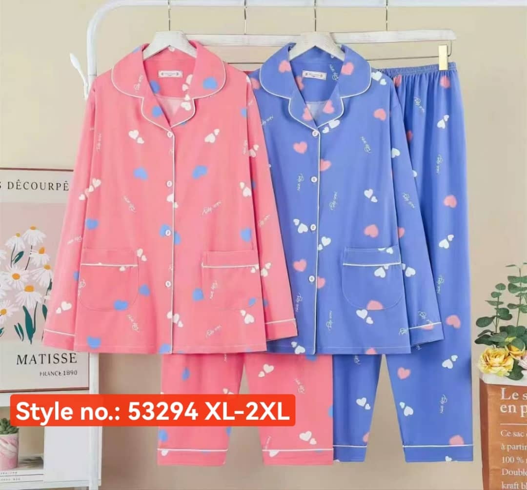 Pink and blue heart print pajama sets displayed on hangers with style number tag.