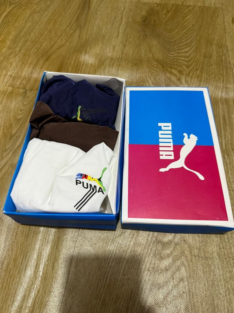 Puma 3-pack briefs in navy, brown and white displayed in open Puma branded box.