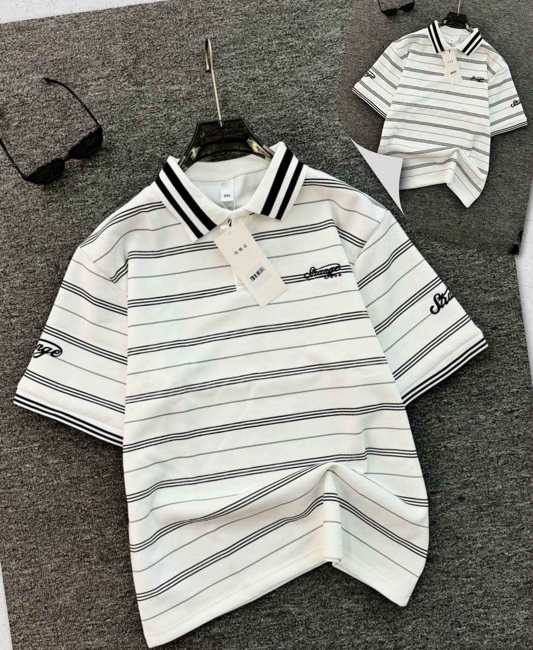 White striped polo shirt with black horizontal stripes, contrast collar and embroidered details.