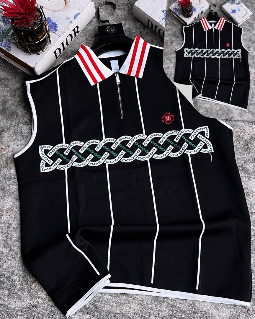 Black armless top with chain embroidery, red striped collar and vertical lines.