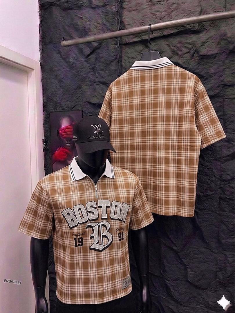 Mannequin in brown plaid polo shirt with Boston graphic, back view hanging on rack.