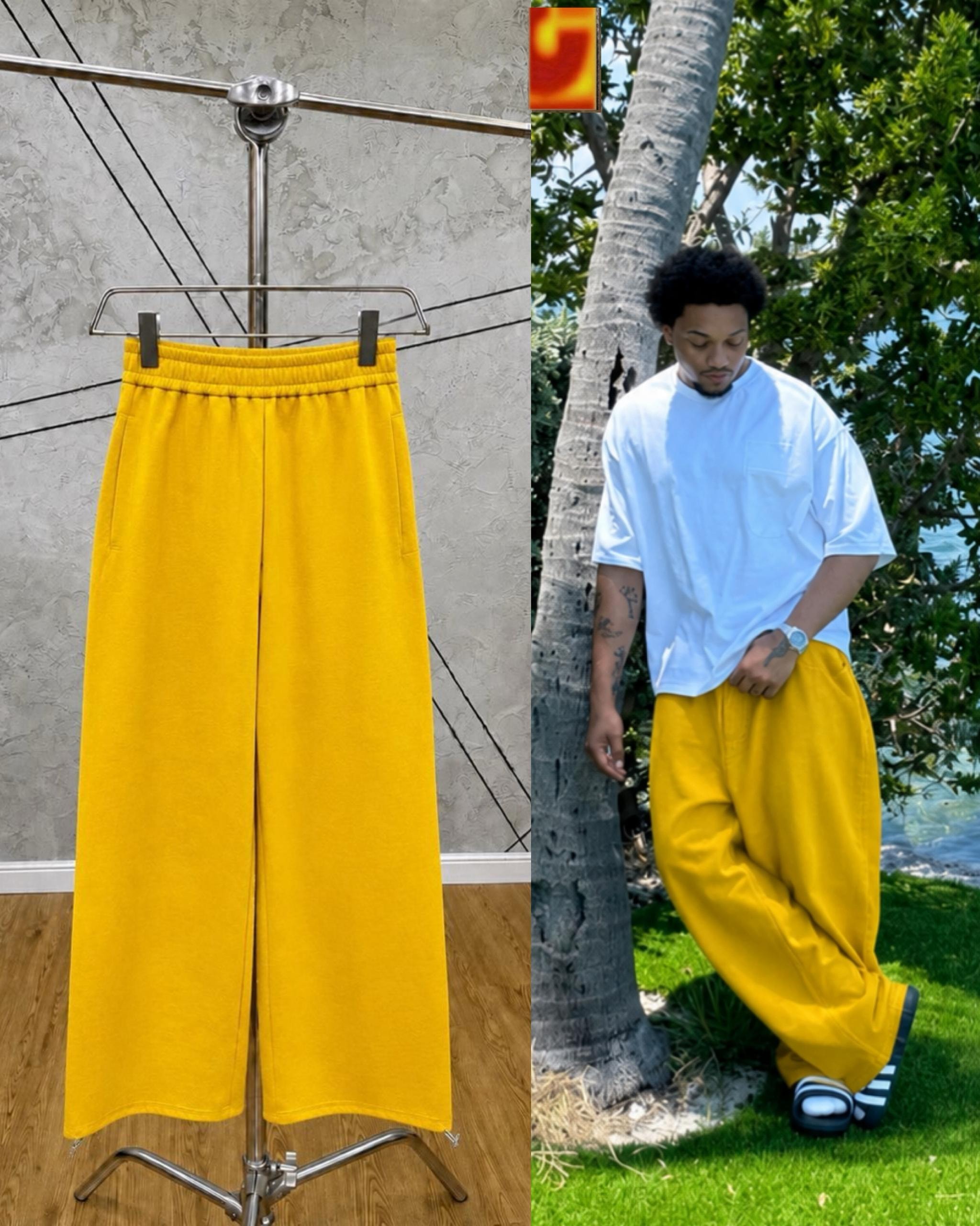 Yellow unisex wide-leg joggers on hanger and model outdoors